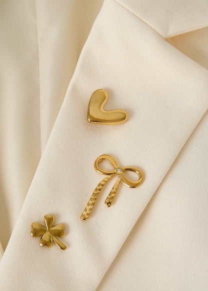 Set met drie broches goud kleur